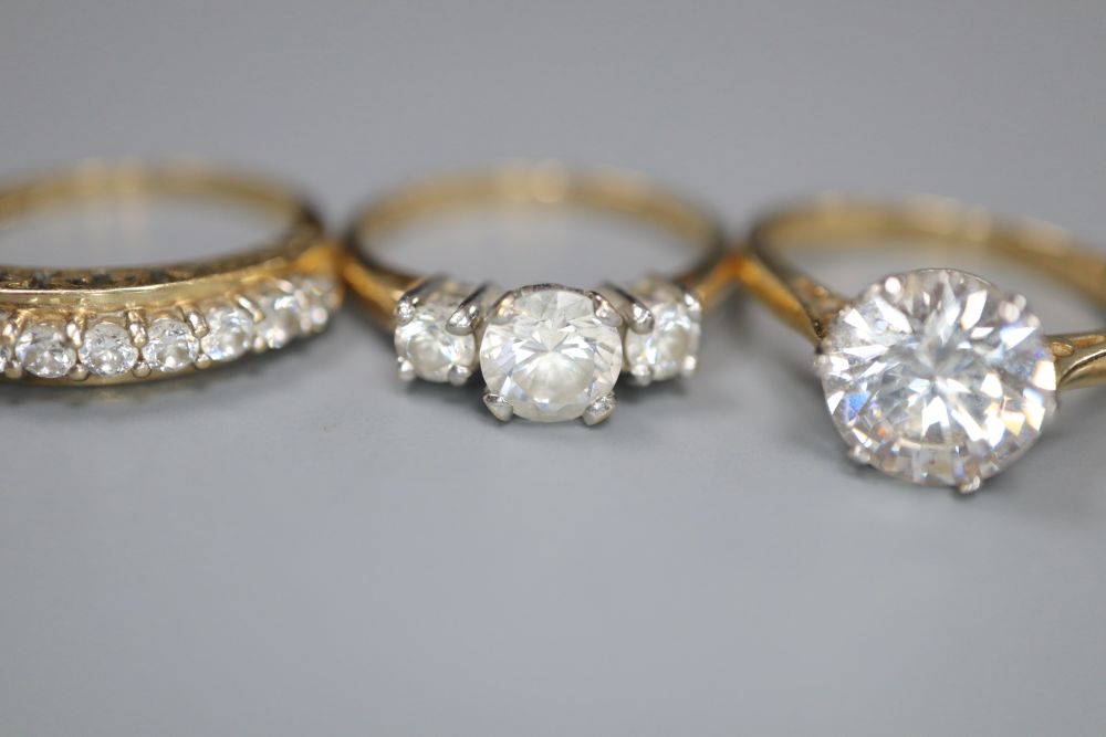 Five assorted modern 14ct gold and CZ set dress rings, gross 13 grams.